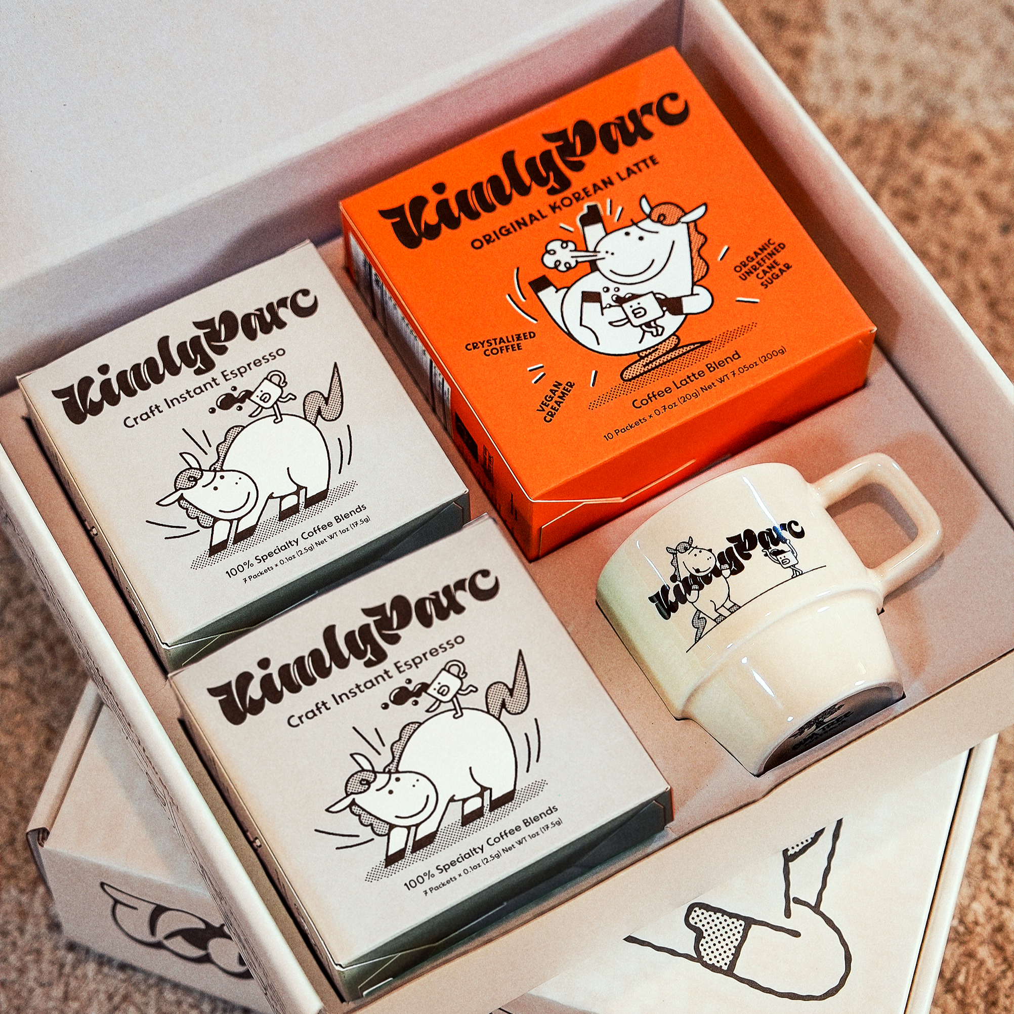 KintsyParc product set including boxes and a mug on a carpeted floor.